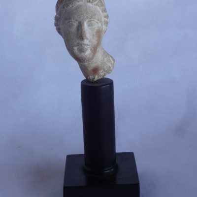 Small hand-carved stone figure of a woman's head, possibly Greek, labelled on bottom "Grecian - 200 BC"