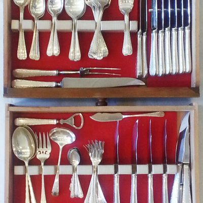 Set of sterling silver Birks flatware, in a two-drawer walnut cutlery cabinet.