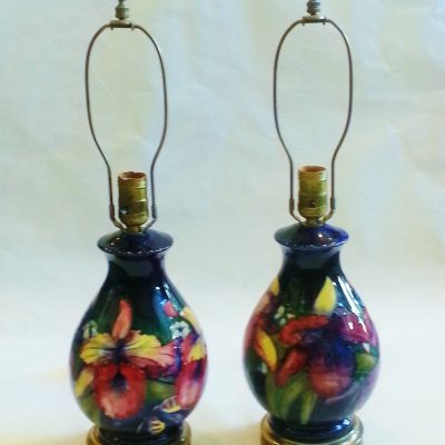Pair of Moorcroft lamps in orchid pattern. With shades (damaged)
