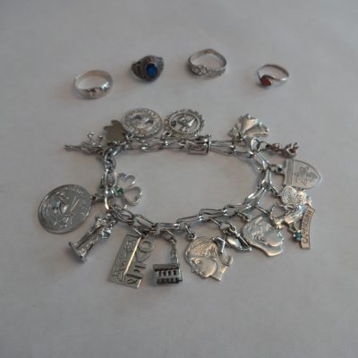 Sterling silver jewelry: charm bracelet and four rings