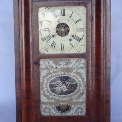Antique "brass" clock by Seth Thomas Clock Co. Enamelled Roman numeral face and reverse-painted eagle motif. Circa 1840s.