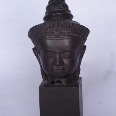 Antique hand-sculpted bronze Thai-style Buddha head, on wooden cube base.