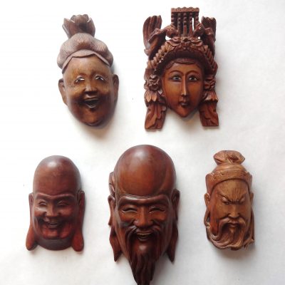Set of five small Chinese masks with ivory teeth