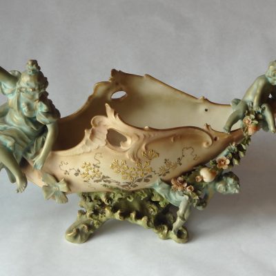 Austrian porcelain boat-shaped flower vase with mother at one end and child at the other. 16"L.