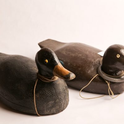 23   Duck decoys.  Hand carved and painted. Two pieces. Lead  mounts. Early 20th century.