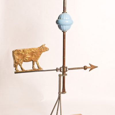 22   Brass weather vane.  Blue milk  glass ball and wooden base.  Early 19th century.    