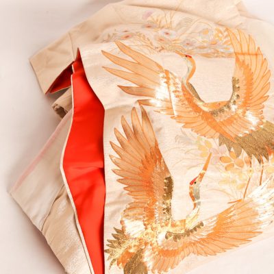 11   Silk Kimono.  Cream and gold   coloured in floral and bird  motif.  Mid 20th century.  With frame and box.