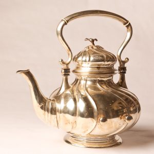 6.  Sterling silver tea pot. Victorian with ivory heat stoppers. With side rests for stand. Late 19th century.  