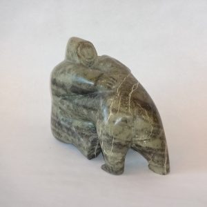 12.  Inuit soapstone carving. Green grained. Depicting a polar bear attacking a hunter.