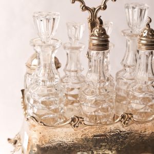 4. Sterling silver vinaigrette set. Early Victorian era. London assay mark. Seven cut crystal bottles with original lids. Mid 19th century.  