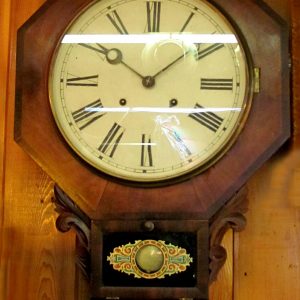 62. Waterbury schoolhouse clock. Octagonal body with short drop, hour strike mechanism on gong. Early 20th century.  